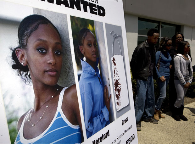 Photo: Monette Hereford and her surviving children stand near a portrait of her slain daughter, Edwinta Hereford during a press conference with the media May 25, 2010 at the Los Angeles County Sheriff's Department Homicide Bureau. Credit: Mark Boster / Los Angeles Times