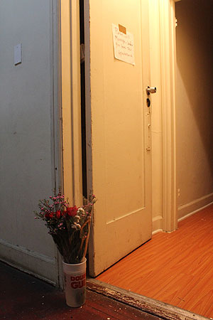Flowers sit at the door to the apartment where Saray Rivas was found dead in a pool of her own blood. Credit: Mary Slosson