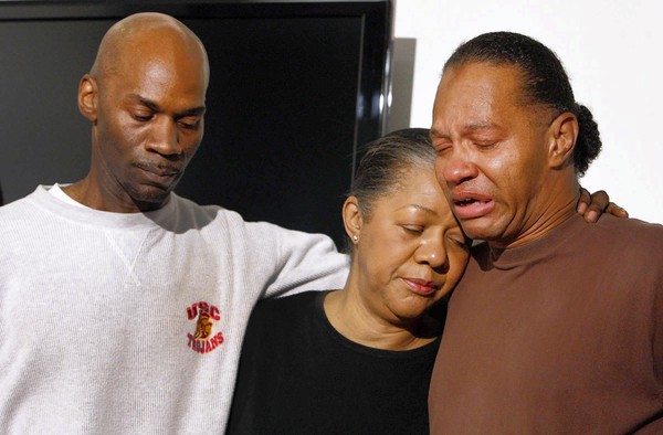 Photo: David White, left, and Anthony White, brothers of Herbert White, appear at the LAPD’s Newton Area station with their mother, Elizabeth Peterson. Credit: Allen J. Schaben / Los Angeles Times.