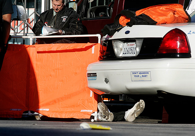 Photo: Officials investigate the death Willy Rosoto-Reyes in the LAPD's Rampart Division Monday morning. Credit: Christina House / For The Times