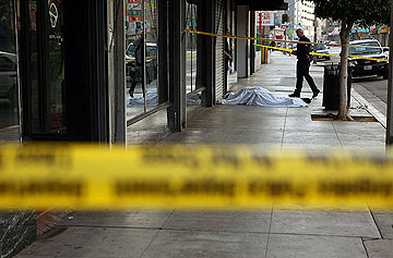 Photo: LAPD officers stand by Conrad Phillip's body Friday near skid row. Credit: Al Seib / Los Angeles Times
