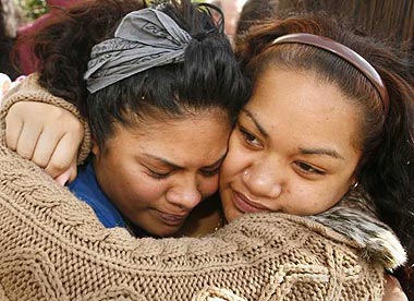 Susie Latweeka (left) cries with her cousin Fiaora Tuitasi (right) near the location in Long Beach where Latweeka's mother, Vanessa Malaepule was found shot to death with four others in what police are calling a homeless encampment November 3, 2008. Credit: Mark Boster/Los Angeles Times