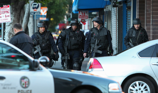 Photo: SWAT officers walk from an apartment on Hollywood Boulevard after taking slaying suspect Paul Matthew Allee into custody. Credit: Katie Falkenberg / For the Los Angeles Times