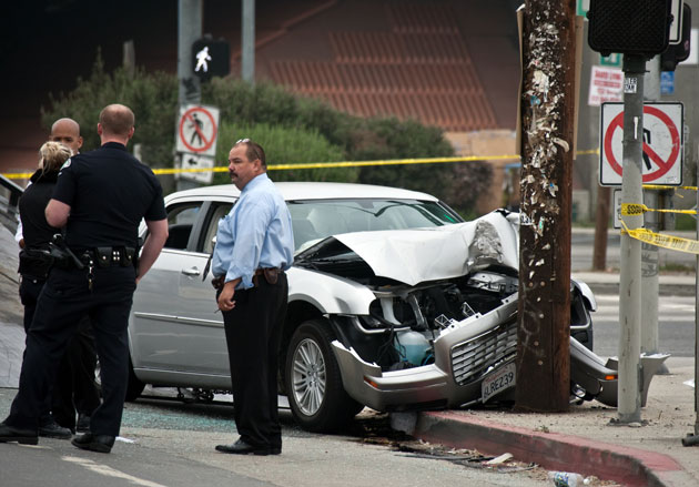 Photo: Police examine the scene where the Wilborns' vehicle crashed. Credit: Irfan Khan / Los Angeles Times