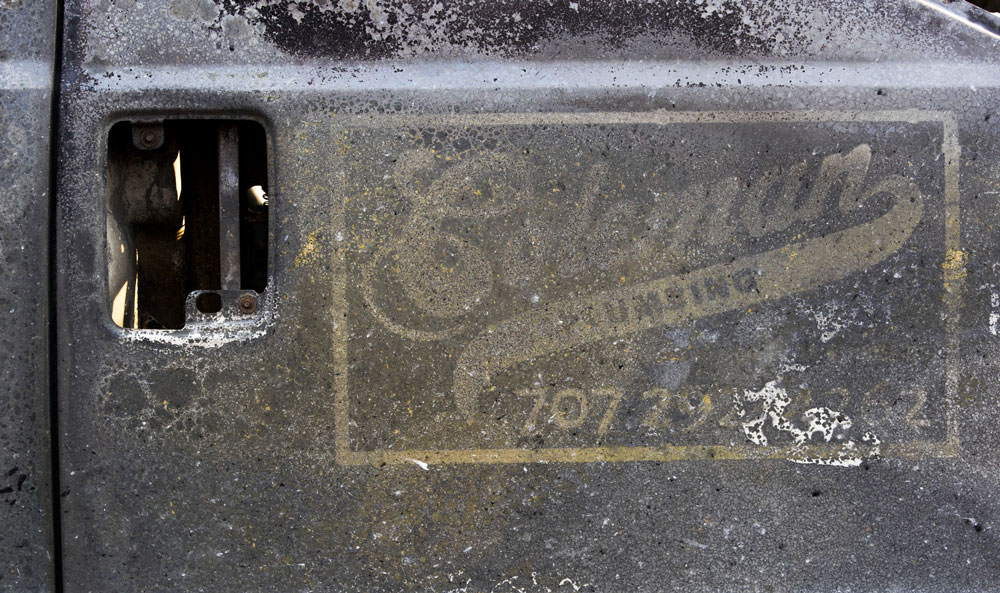 Coleman Plumbing logo damaged from heat and fire