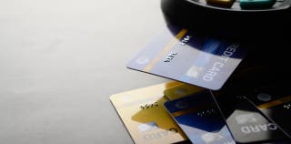 Four credit cards fanned out on a table