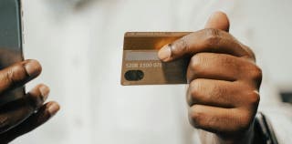 A person holding a Capital One SavorOne card