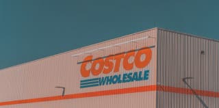 Costco wholesale logo printed on the corner of a Costco store