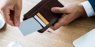 A person pulling a credit card out of their wallet