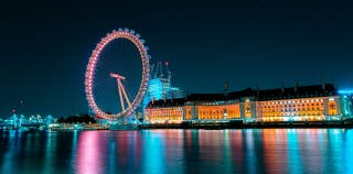 View of the London Eye cantilevered observation wheel from the banks of the Thames at night