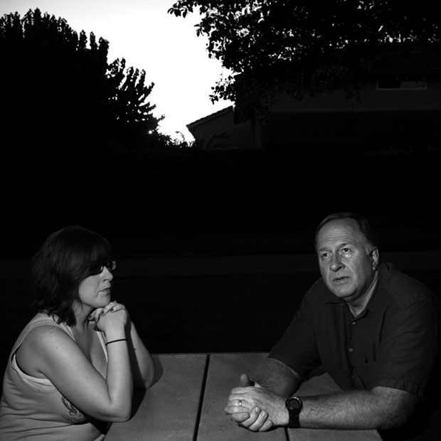 Charles Thurber, an Orange County sheriff's deputy, sits with his daughter, Danielle, at a park near their home in Fountain Valley.