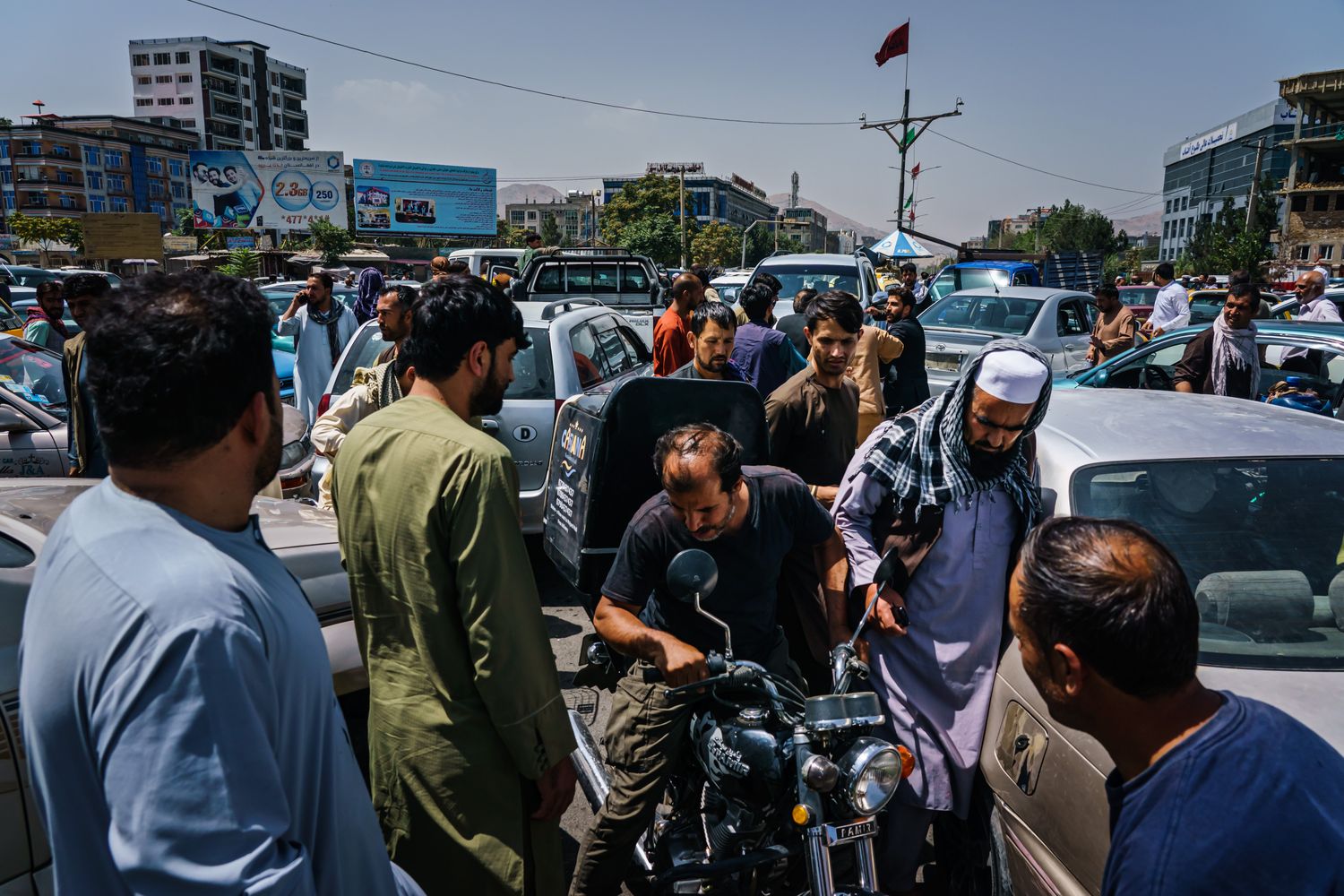 Pedestrians and a motorcyclist move within clogged traffic.
