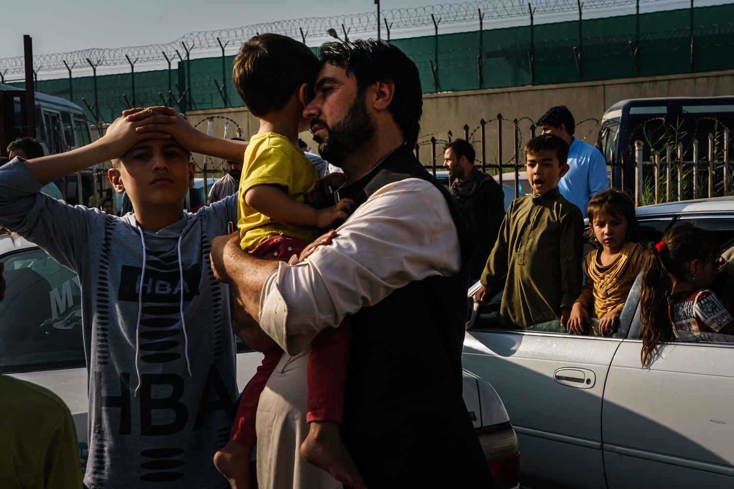 A father rests his head on his child’s face.