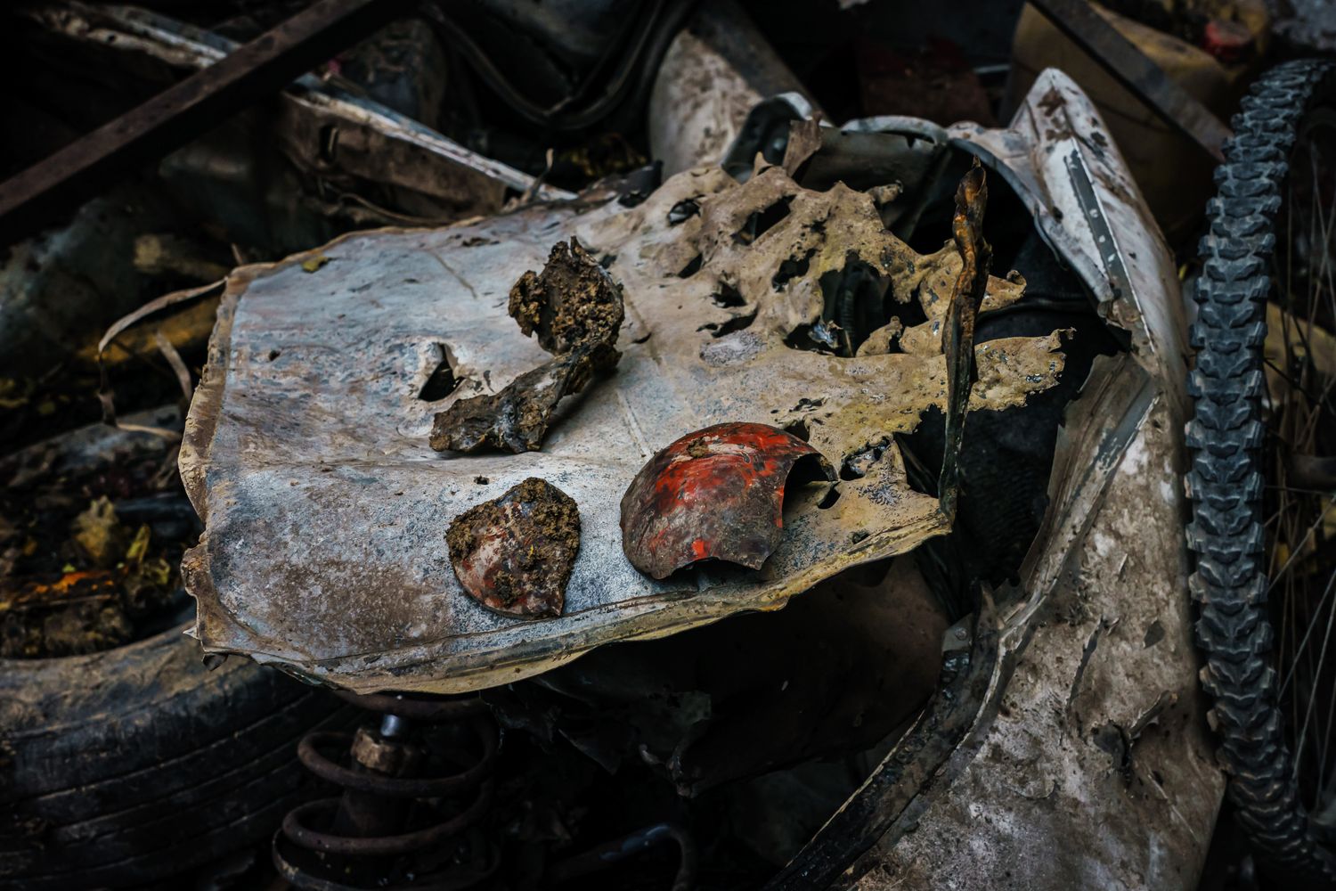A piece of a missile sits on the charred wreckage of a vehicle hit by a drone strike.