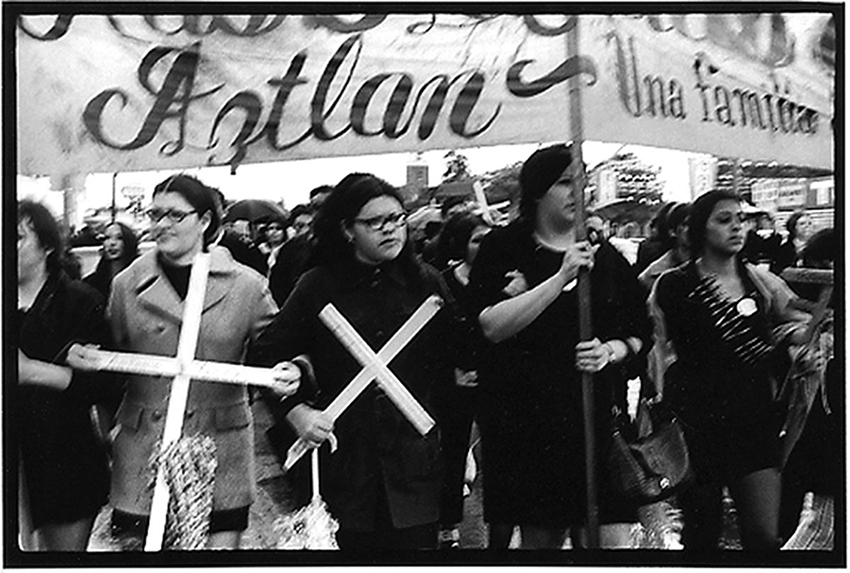 Members of Las Adelitas de Aztlán hold crosses bearing the names of fallen soldiers at the second Chicano Moratorium protest against the Vietnam War on Feb. 28, 1970.