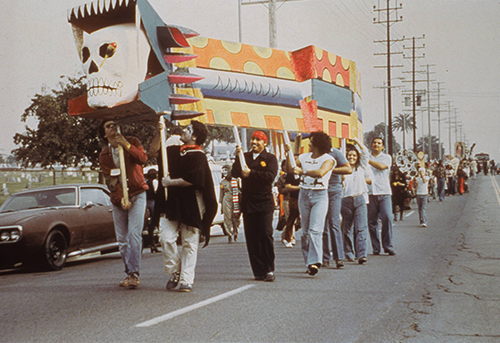 Group of people marching during a Day of the Dead procession