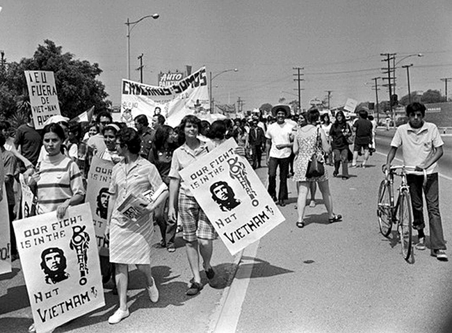 Chicano Moratorium Committee antiwar demonstrators carry signs as they march in East Los Angeles