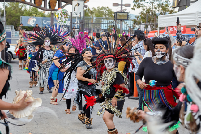 People dance during a Day of the Dead procession in 2019.
