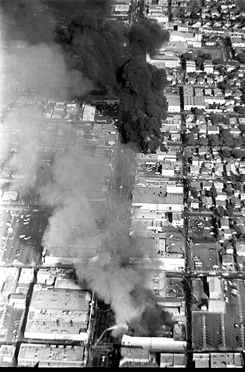Aerial view of Whittier Boulevard, showing smoke from two fires after rioting broke out during the Chicano Moratorium march on August 29, 1970.