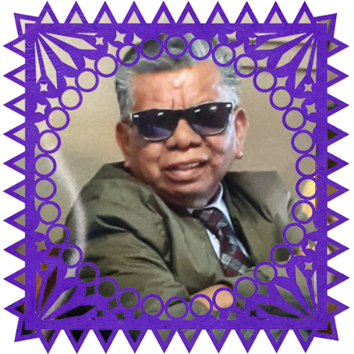 Photo of Abraham Ramirez in a frame with papel picado.