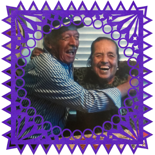 Photo of Abuelos Reyes e Inés Echeveste in a frame with papel picado.
