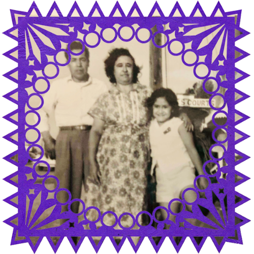 Photo of Abuelos y primas in a frame with papel picado.