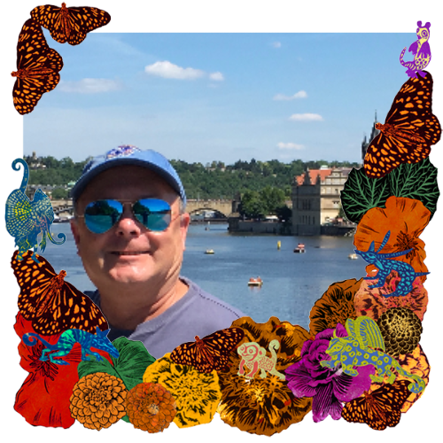 Photo of Alan Hagman in a frame with marigolds, flowers, alebrijes and monarch butterflies.