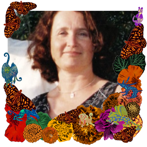 Photo of Anne Marie O'Riordan in a frame with marigolds, flowers, alebrijes and monarch butterflies.