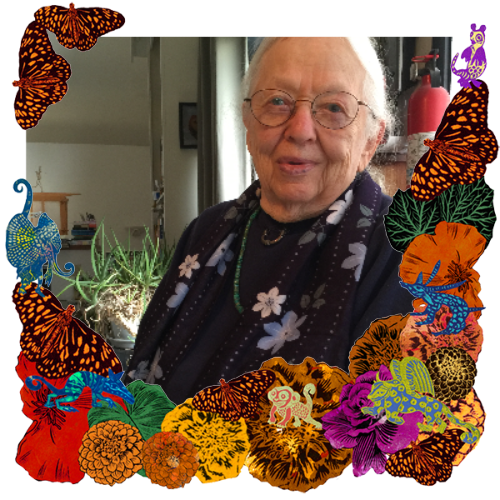 Photo of Annie Cribbs in a frame with marigolds, flowers, alebrijes and monarch butterflies.
