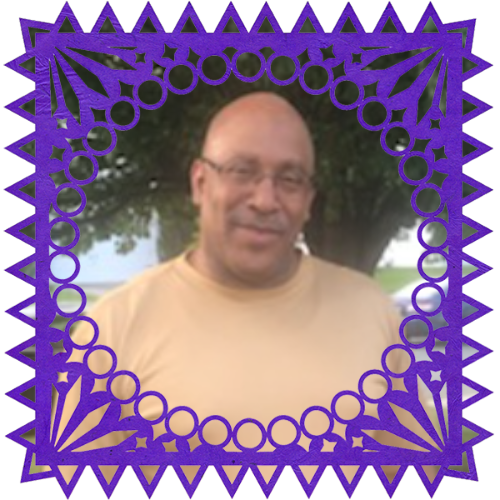 Photo of Anthony Tinsley in a frame with papel picado.
