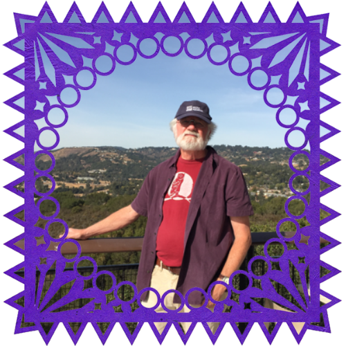 Photo of Bill O'Brien in a frame with papel picado.