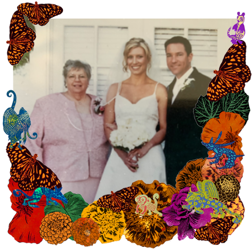 Photo of Carolyn Glover in a frame with marigolds, flowers, alebrijes and monarch butterflies.