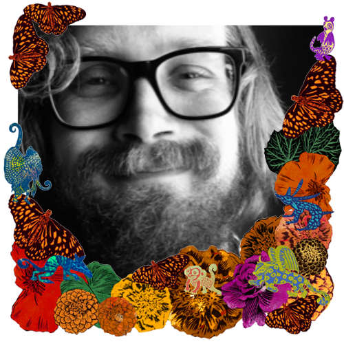 Photo of Chris Davis in a frame with marigolds, flowers, alebrijes and monarch butterflies.