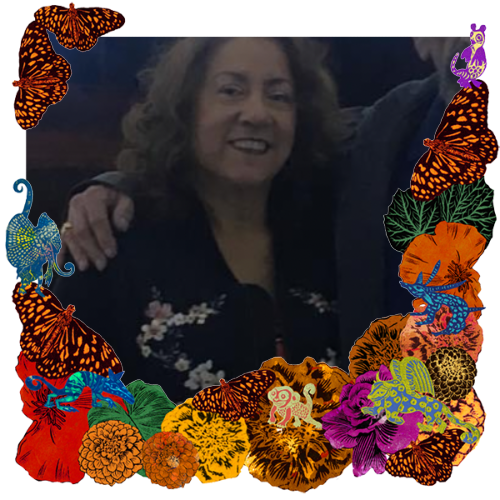 Photo of Christine Castillo in a frame with marigolds, flowers, alebrijes and monarch butterflies.