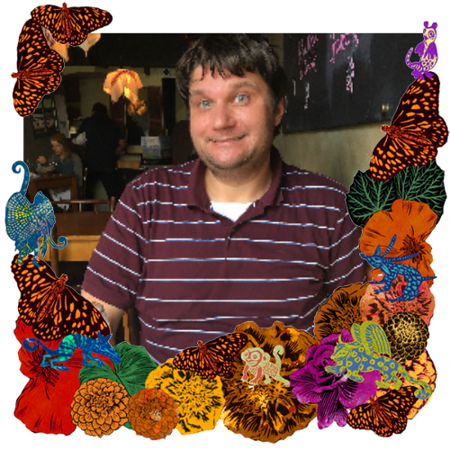 Photo of Colin in a frame with marigolds, flowers, alebrijes and monarch butterflies.