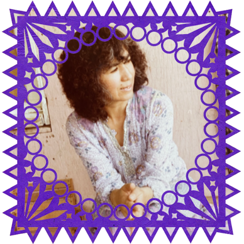 Photo of Delfina Landeros in a frame with papel picado.
