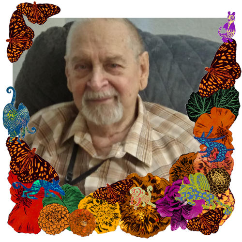 Photo of Ed in a frame with marigolds, flowers, alebrijes and monarch butterflies.
