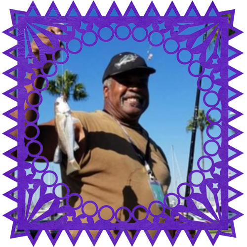 Photo of Ernest Lee Polk in a frame with papel picado.