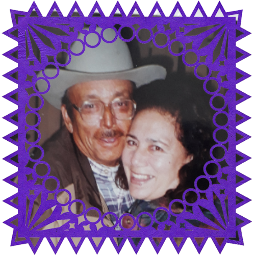 Photo of Francisco y Delia in a frame with papel picado.