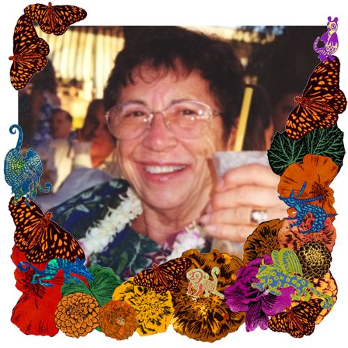 Photo of Gloria McKimmey in a frame with marigolds, flowers, alebrijes and monarch butterflies.
