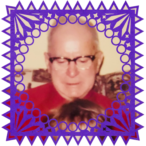 Photo of Grandpa in a frame with papel picado.