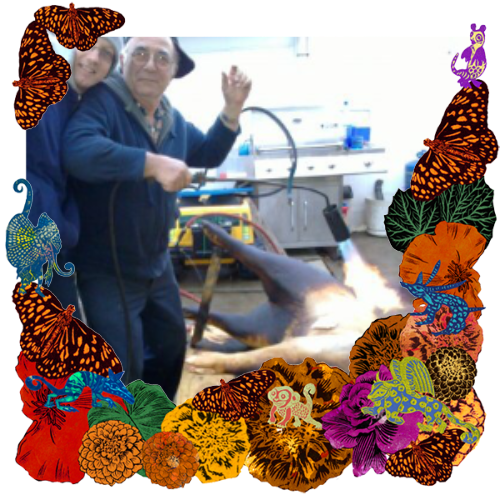 Photo of my grandpa in a frame with marigolds, flowers, alebrijes and monarch butterflies.