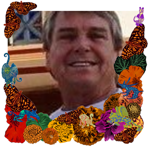 Photo of Hans Loudermilk in a frame with marigolds, flowers, alebrijes and monarch butterflies.