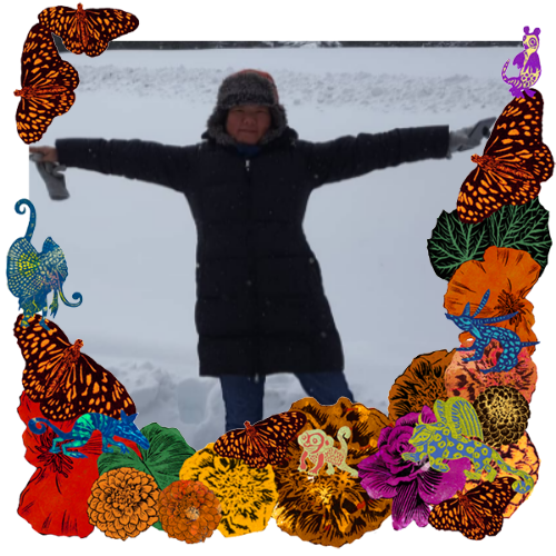 Photo of Haruko Tanaka in a frame with marigolds, flowers, alebrijes and monarch butterflies.