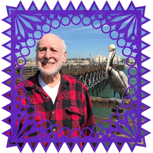 Photo of Harvey Oshrin in a frame with papel picado.