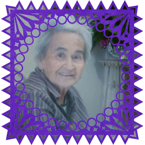 Photo of Herminia León in a frame with papel picado.