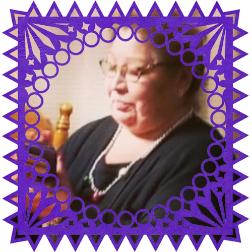 Photo of Hilda De La Rosa in a frame with papel picado.