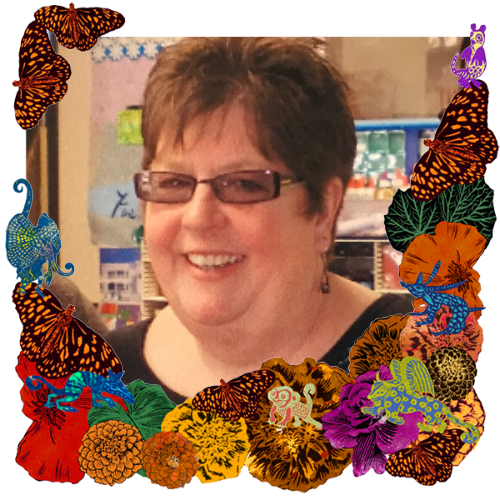 Photo of Irene Cook in a frame with marigolds, flowers, alebrijes and monarch butterflies.