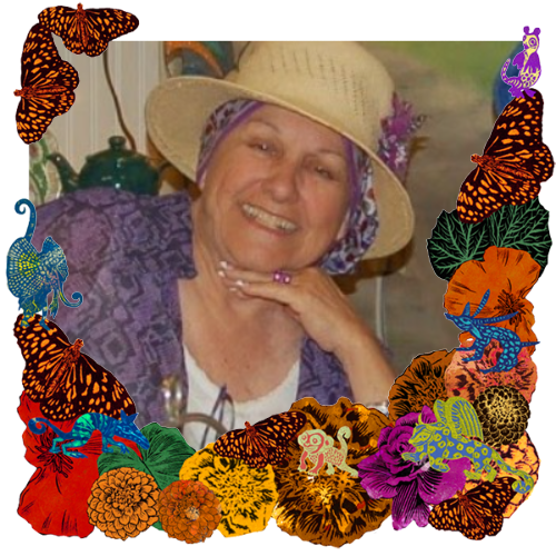 Photo of Jean Graves in a frame with marigolds, flowers, alebrijes and monarch butterflies.