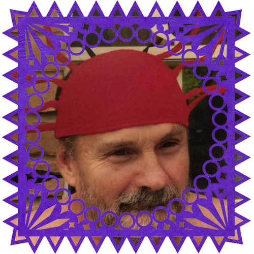 Photo of Jim Stebel in a frame with papel picado.